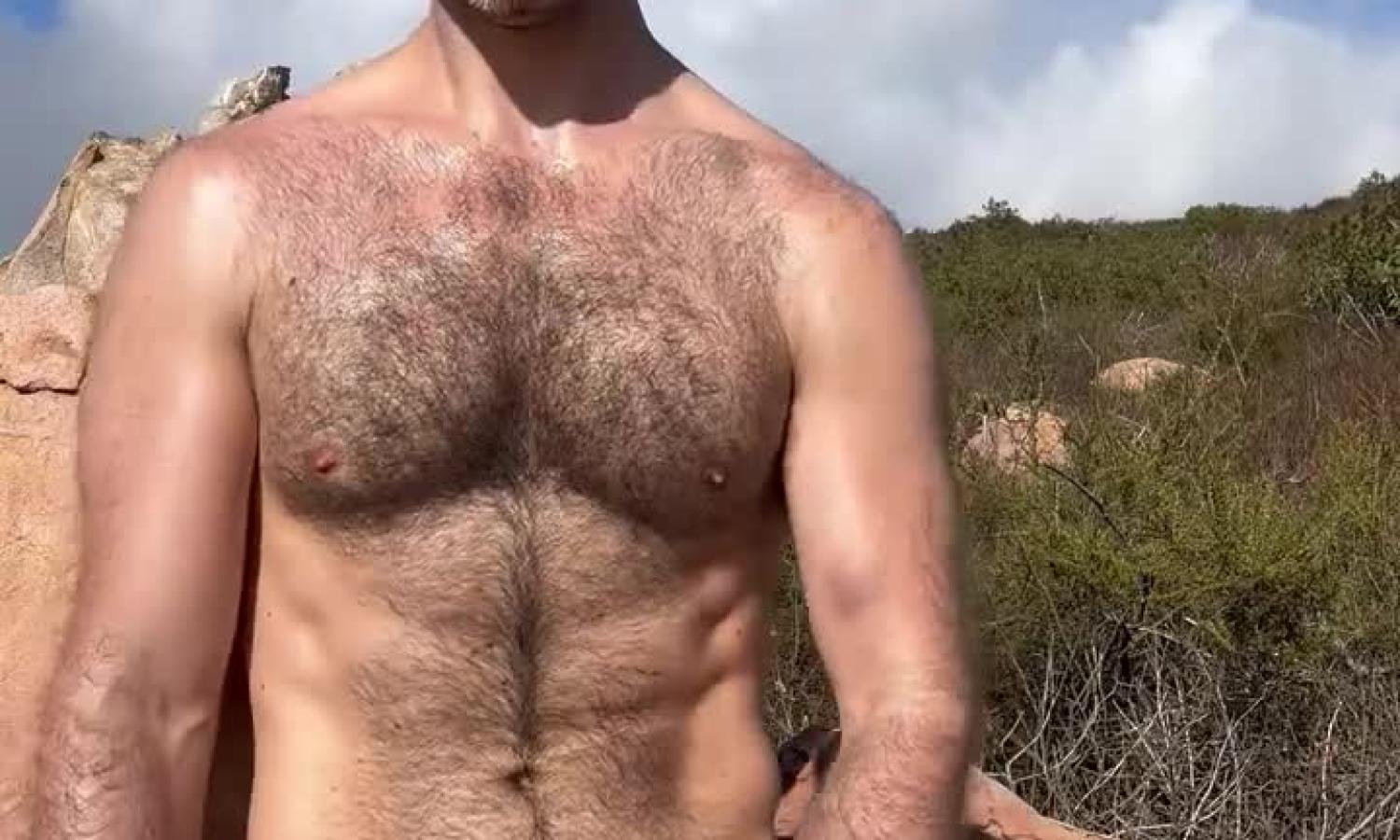 Hairy guy jerks off on a hike