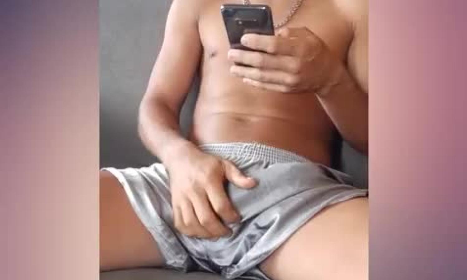 Hung guy playing with his dong while chatting by phone