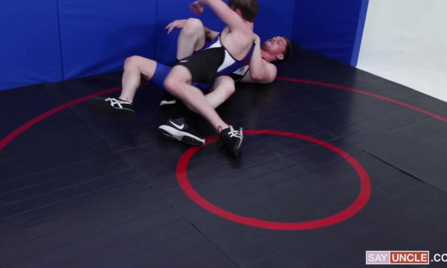 Varsity Grip: Jay Tee wearing uniform wrestling